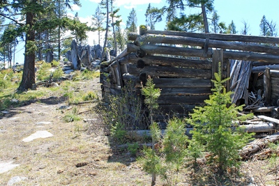 Scenic 'Stonehenge' type rock formation (upper left) seen above Coloma (ghost town) in the Garnet mountains of Montana.  Collapsed cabin in foreground.