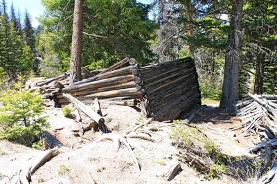 One of the collapsed cabins in the main section of Coloma (ghost town).  The foundation on the left side seems to have been washed out by running water causing the subsiding on that side of the structure.