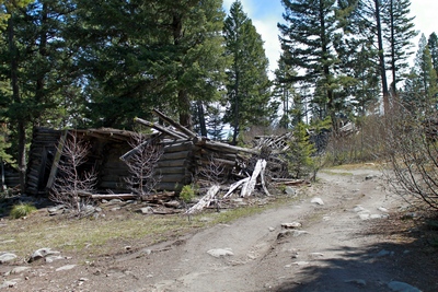 Very rough road to the main part of Coloma (ghost town) with a collapsed cabin on the left.