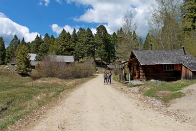 Main entrance road with the staff office cabin on the right which is one of the better preserved cabins but occupied for staff only.