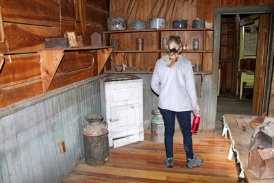 Diana browsing the kitchen of the Wells Hotel in Garnet Ghost Town.