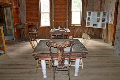 Dining area in the Wells Hotel in Garnet, MT.  Most of the remaining buildings  in Garnet have been stabilized to make it safe for visitors to explore.  Two vertical support posts can be seen in the middle of  the far wall to add rigidity to the structure.