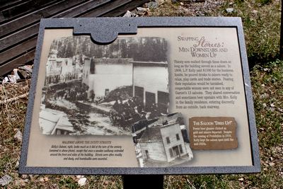 Sign outside Kelley's saloon.  L. P. Kelley paid $1500 for the business.  Inside, he poured drinks to miners ready to relax, play cards & trade stories.  A wooden walkway extended around the front & sides. Respectable women were not seen in any of Garnet's 13 saloons. 