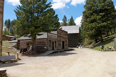 The two buildings with the wooden walkway are the restored remains of Frank A. Davey's store built around 1898.  Behind that are the restored remains of the J.K. Wells Hotel.  To the left, outside of the picture is the location of Kelley's Saloon.
