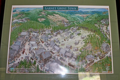 Framed & matted 3D depiction map of the original Garnet, MT hangs on the wall in the Visitor's Center cabin.